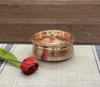 Introducing our Copper Stainless Steel Double Wall Biryani Gravy Serving Handi, the epitome of elegance and functionality. Crafted with premium quality copper and stainless steel, this handi ensures even heat distribution for perfectly cooked biryani gravy every time. Its double-wall construction keeps your delicious dish warm for longer, delighting your guests with piping hot servings. Elevate your dining experience with our exquisite handi, designed to complement any table setting while serving up aromatic and flavourful biryani with style and grace. Size: Handi/Lagan 15.5 x 6.5 cm/ 6 x 2.5 Inch – Lid 15.5 x 2.5 cm / 6 x 1 Inch Capacity: 600 ml (2 Portion)